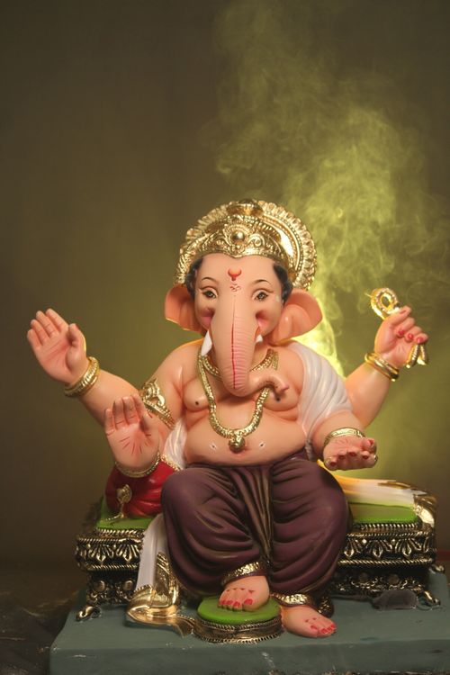 Free Close-up of a Ganesha statue with smoke, symbolizing spirituality and Hindu culture. Stock Photo