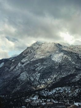Scenic view of snow-dusted mountains under a cloudy sky in Quetta, Pakistan.