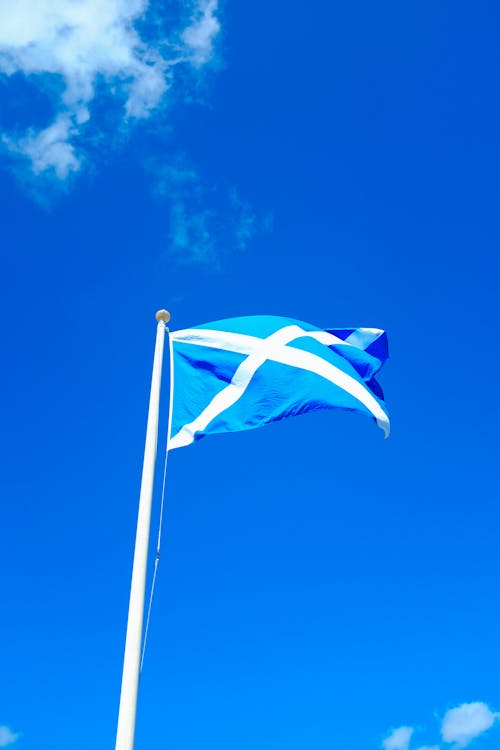 Free The Flag of Scotland under a Clear Blue Sky Stock Photo