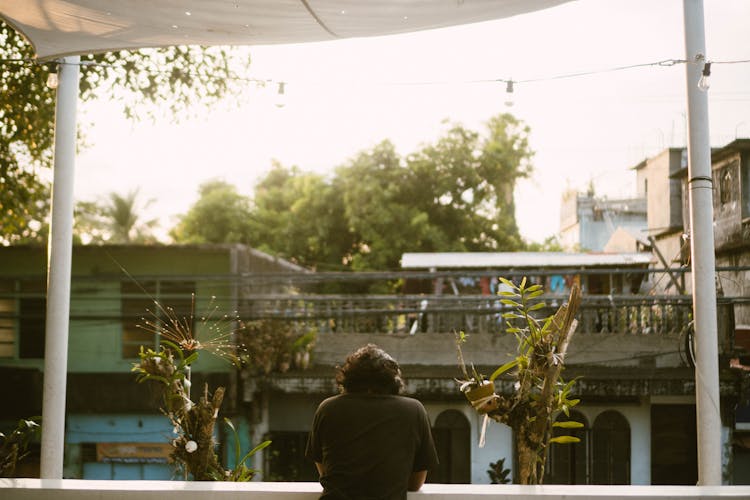 Man Standing On Balcony