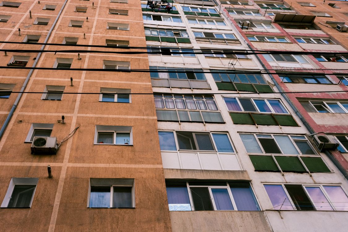 Low-Angle Shot of a High-Rise Brown and White Concrete Building · Free ...