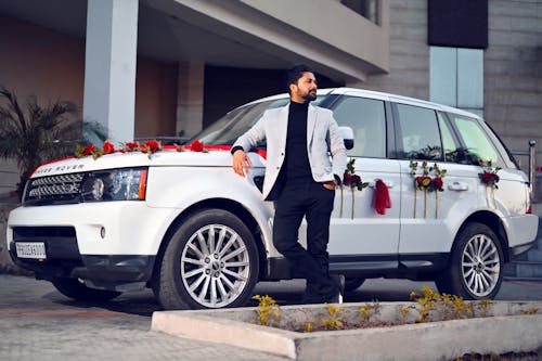 A Man Leaning on a White Range Rover