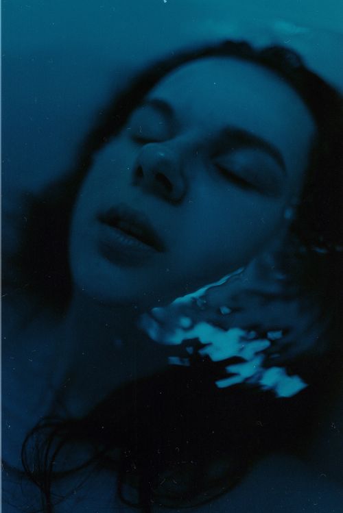 Free Artistic close-up of a woman's serene face underwater captured in low light. Stock Photo