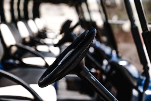 Selective Focus Photography Of Golf Cart Steering Wheel