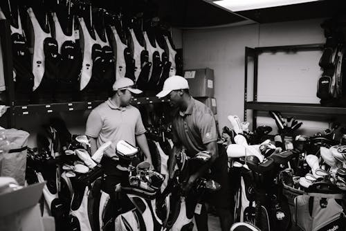 Free Grayscale Photography Of Men Surrounded By Golf Clubs Stock Photo
