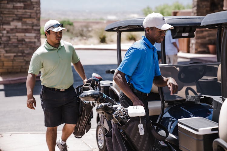 Two Man Standing Beside Golf Carts