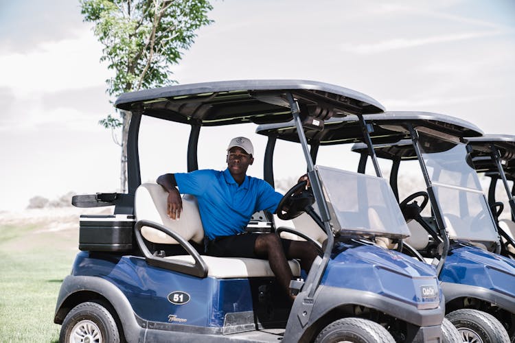 Man Riding On Golf Cart