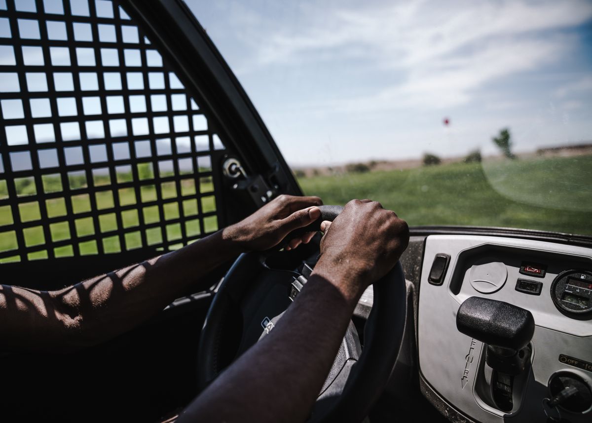 Golfer preparing to tee off on a golf course at sunset