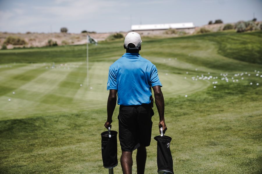 Golfer walking tall down the fairway after a mobility session
