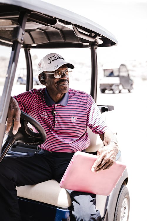 Free Photo of Man Sitting on Golf Cart Stock Photo