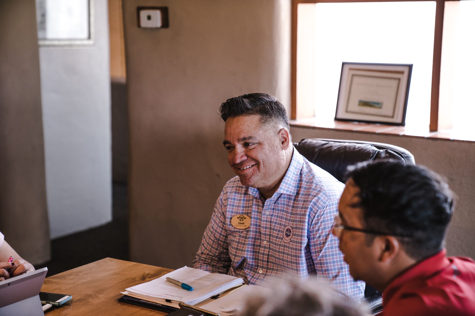 Smiling team members engaging in a positive office discussion.