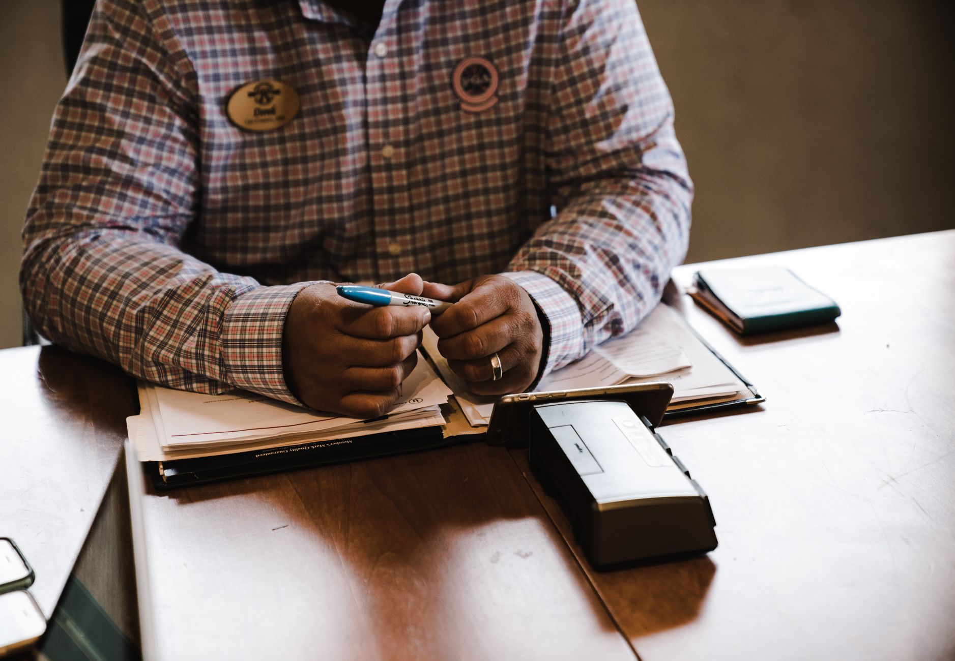 A businessman with documents, organizing and working at his desk for an office task.