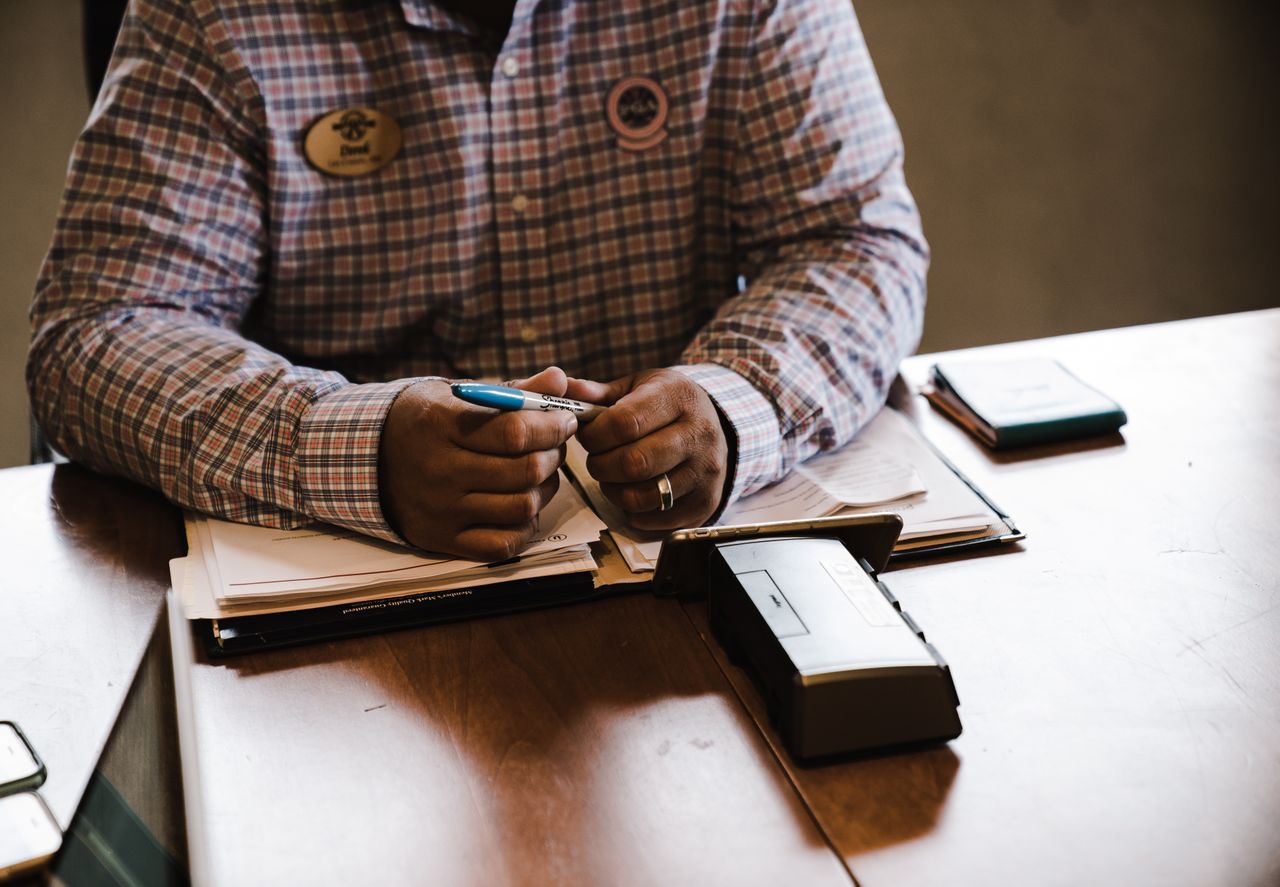 Sales handoff checklist and CRM account document on a desk