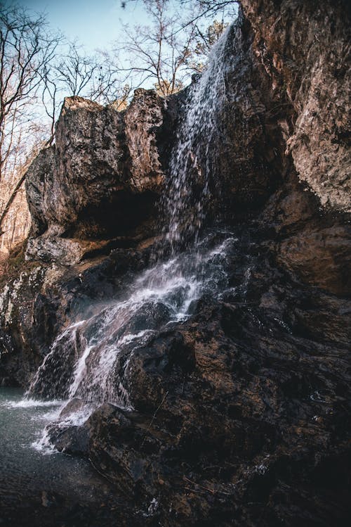 Free A Waterfall on a Rock Formation Stock Photo