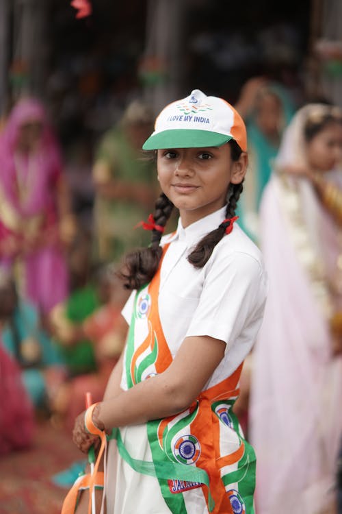 Young Girl Wearing a Cap in Colors of the Flag of India at a Festival 