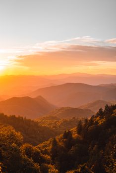Breathtaking sunset view over lush mountains and forest landscape.