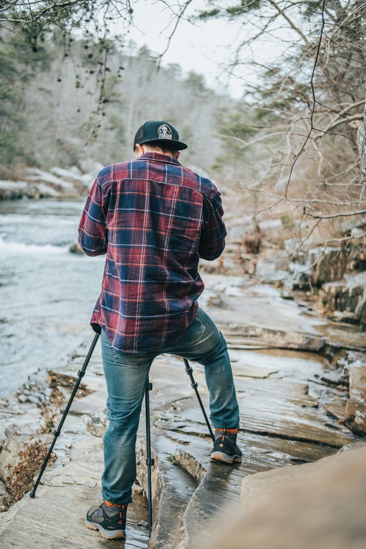 Man Photographing River In Mountains 