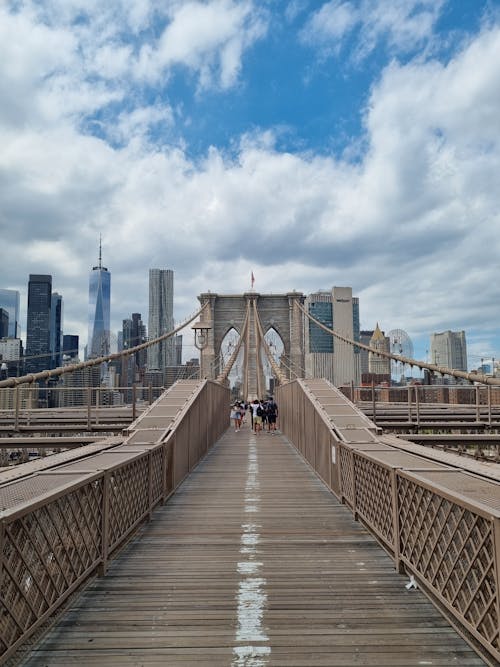 People Walking on Brown Wooden Bridge