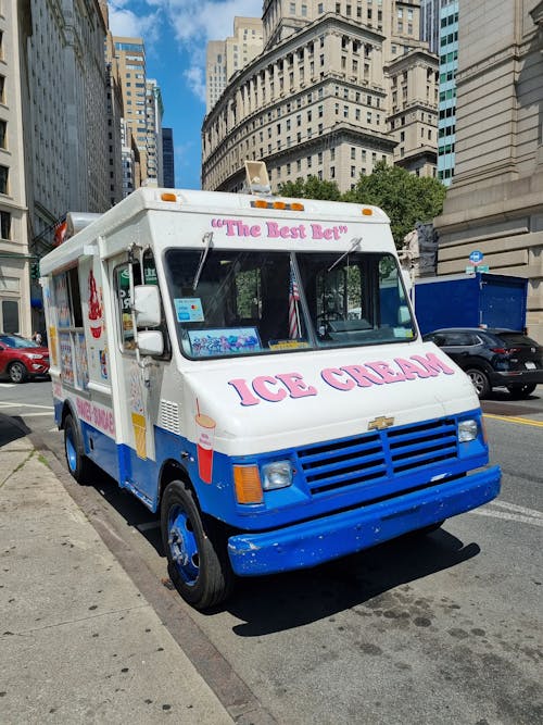 White and Blue Van on the Road