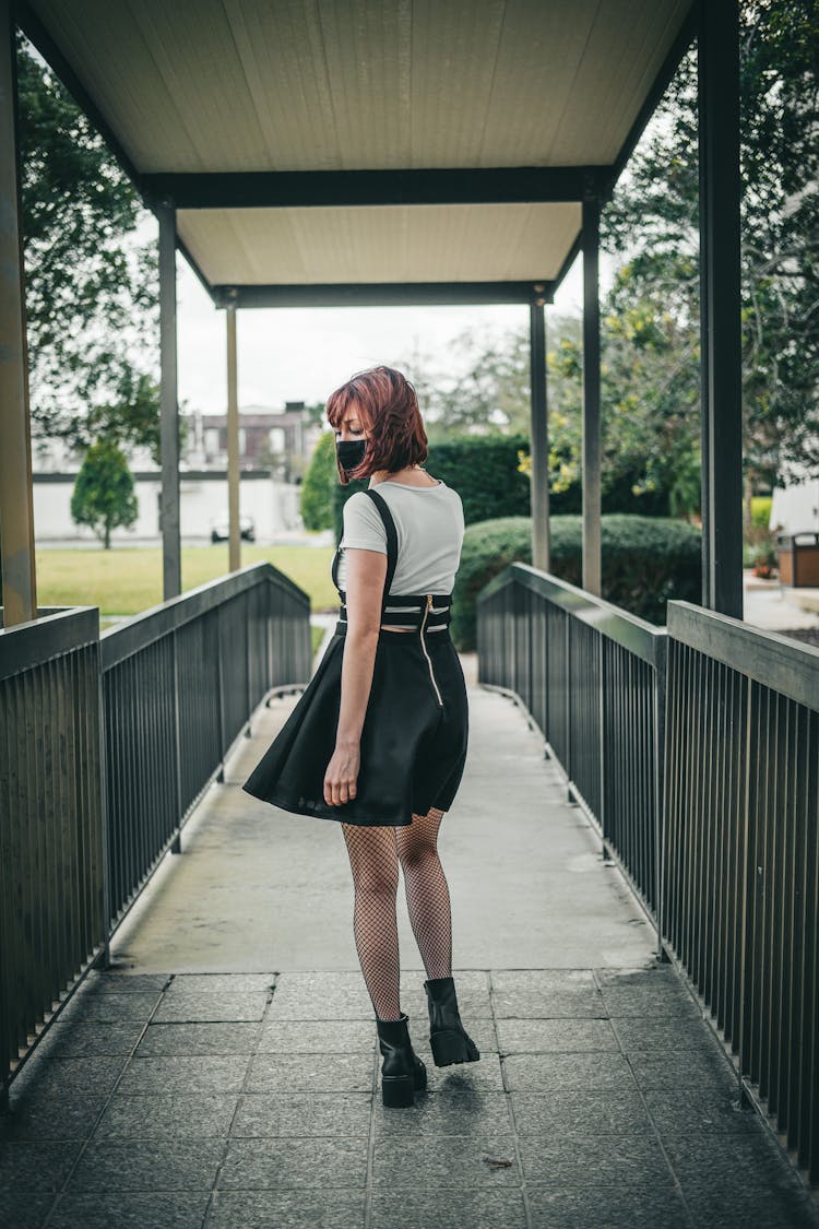 Woman In Face Mask Walking On Bridge