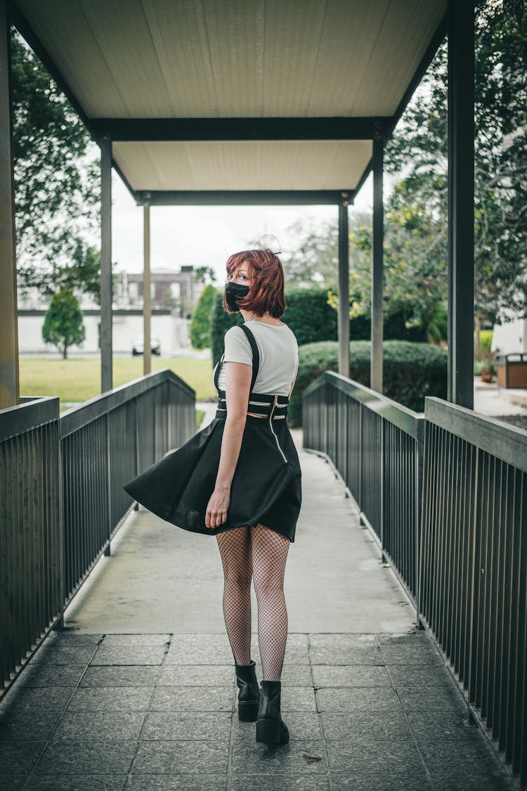 Woman In Face Mask Walking On Bridge