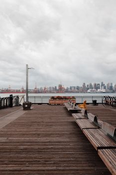 A peaceful view of a wooden boardwalk overlooking Vancouver's skyline.