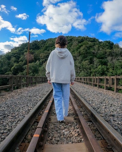 A Woman Standing on Railroad Track