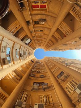 Fisheye perspective of a residential building's interior spiral in Alexandria, Egypt.