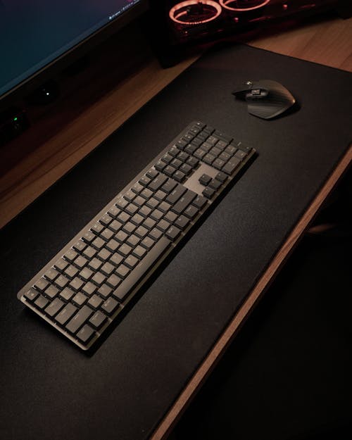 Black Computer Keyboard on Black Wooden Desk