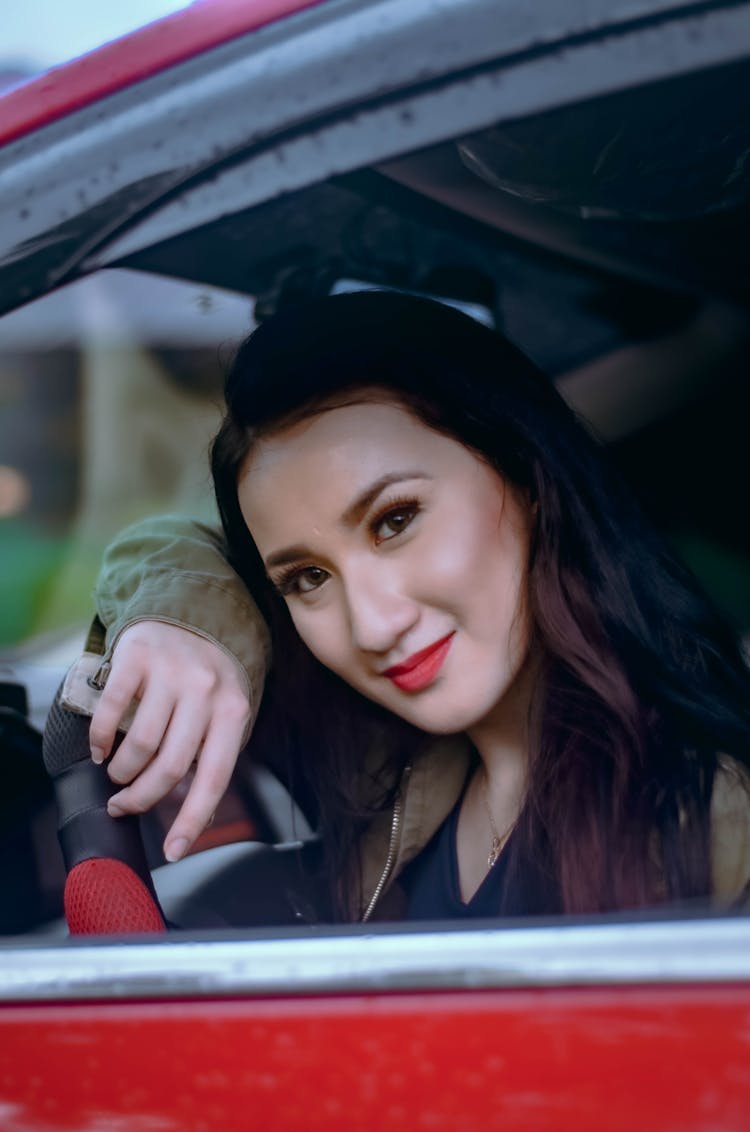 A Woman Riding A Car 