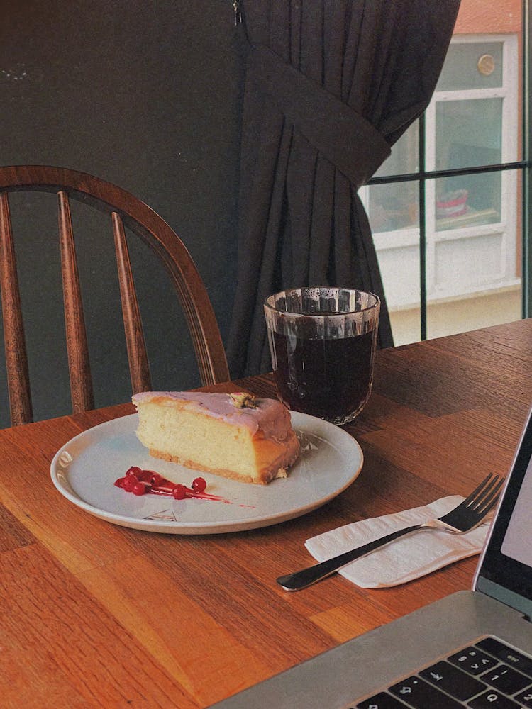 A Slice Of Cake Beside A Beverage