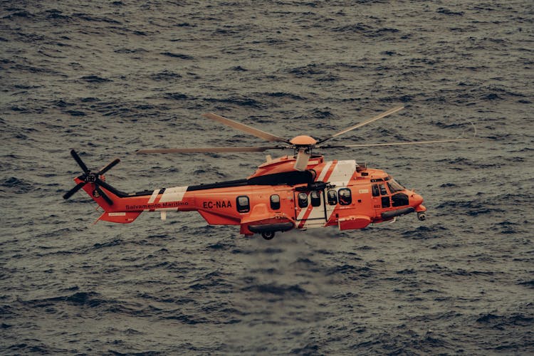 A Rescue Helicopter Over The Sea Water