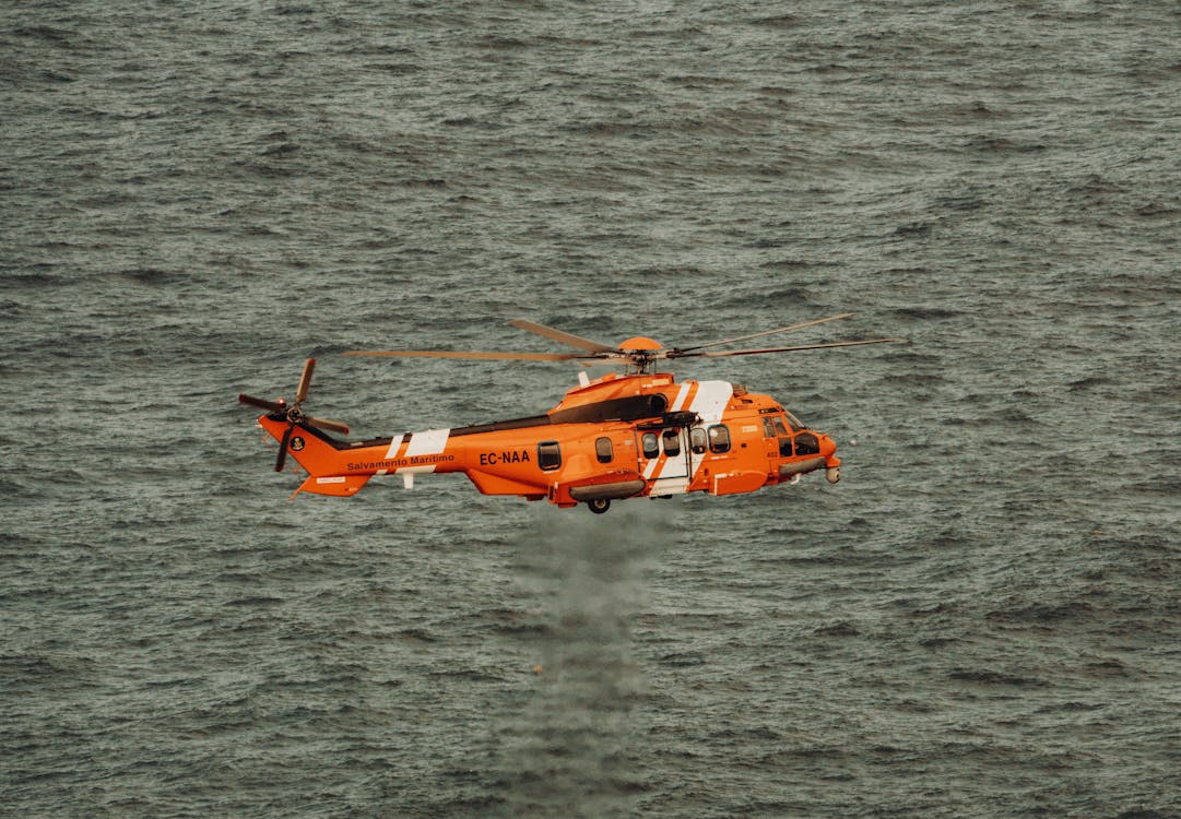 A Spanish Maritime Safety Agency EC225 Flying over Water · Free Stock Photo