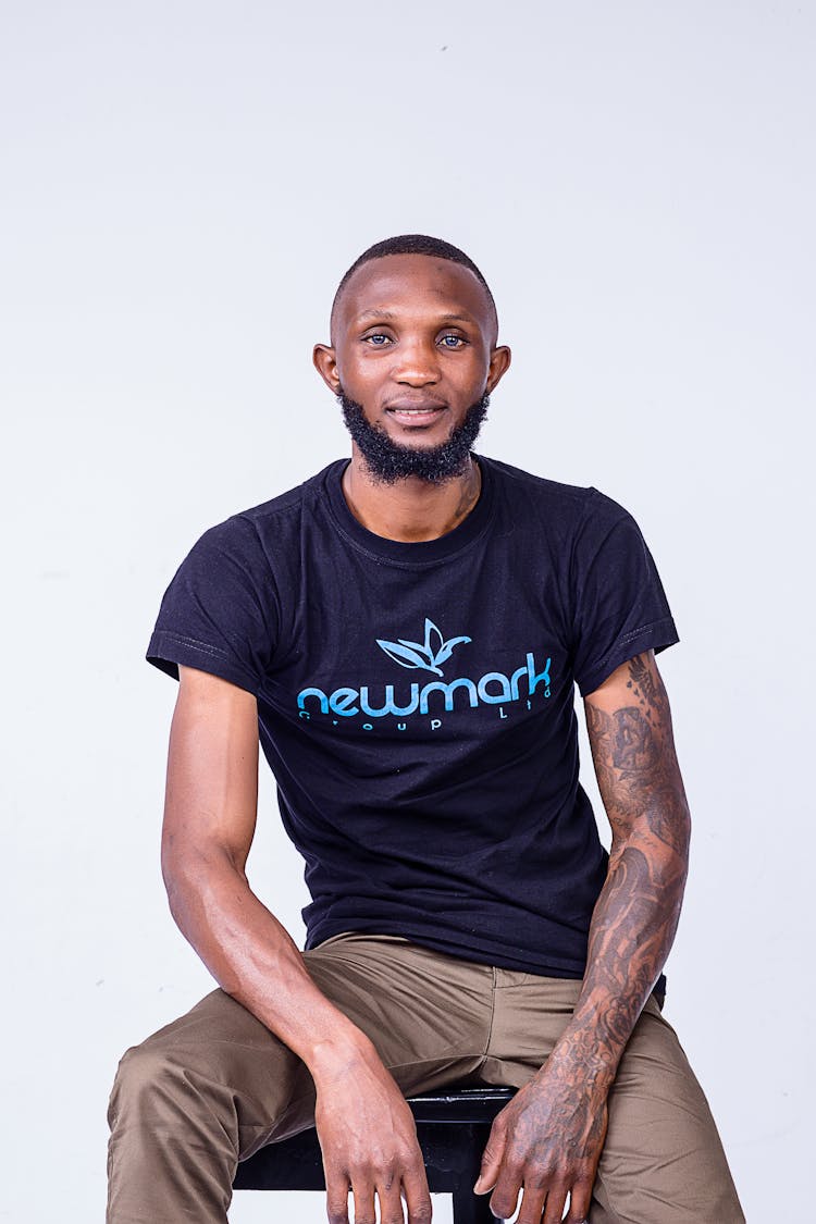 Bearded Man With Tattoos Posing In White Studio