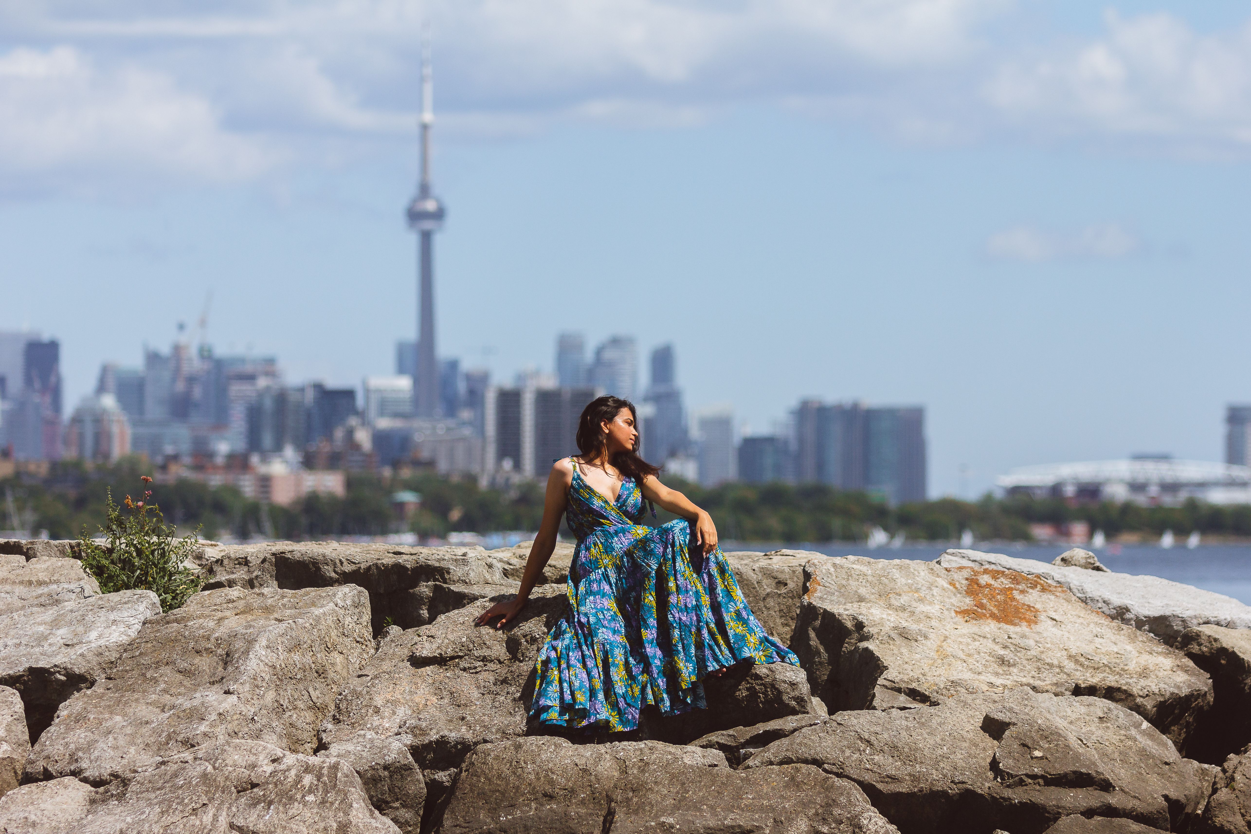 Woman in a Floral Dress Sitting on a Rock · Free Stock Photo