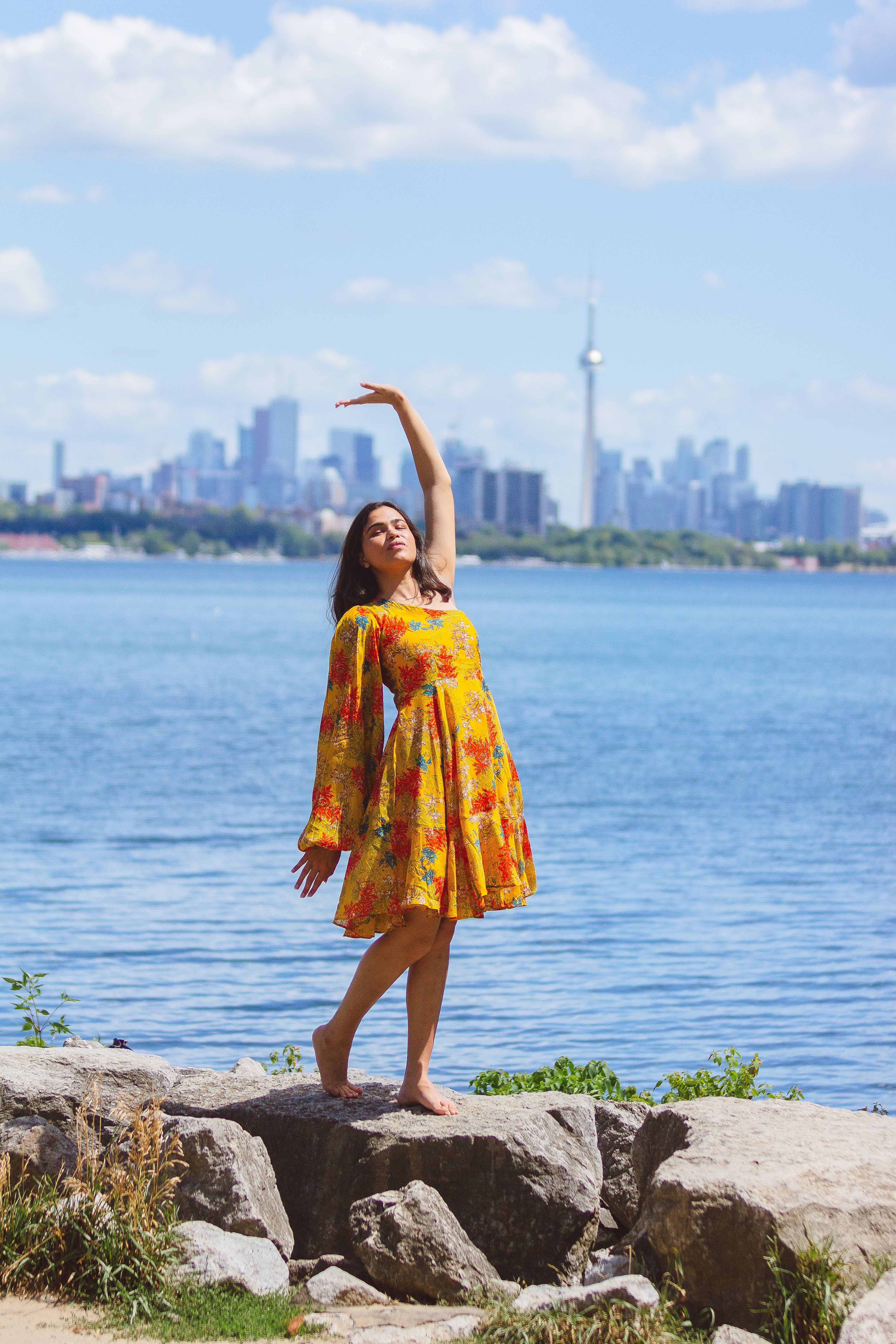 Woman in Floral Dress Standing on the Rock near Ocean · Free Stock Photo