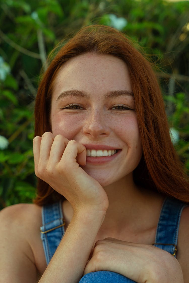 Beauitful Redhead Woman In Overalls Smiling 