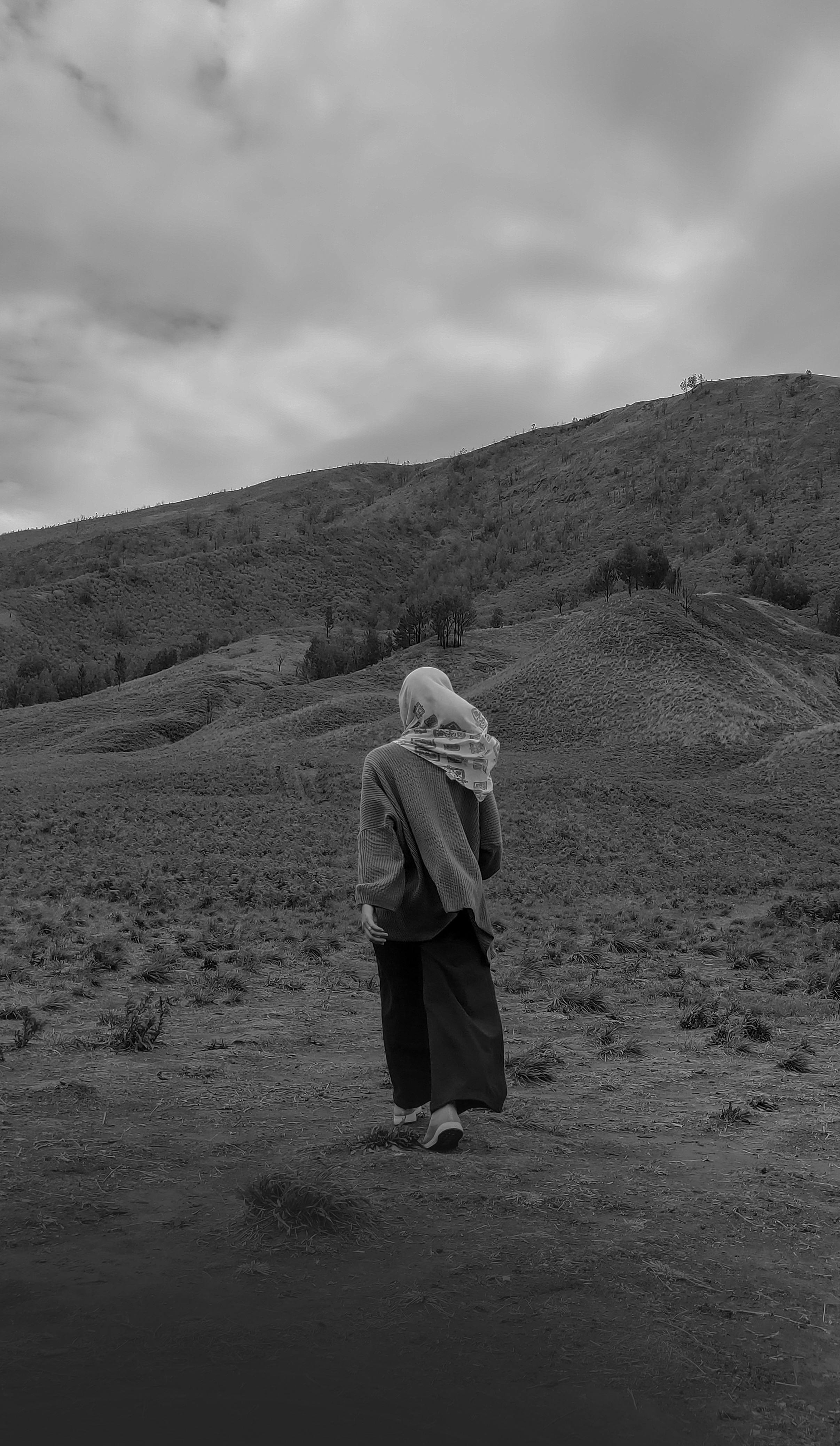 Back View Shot Of A Woman In Black Bodysuit Standing On Grass Field While Stretching Arns · Free