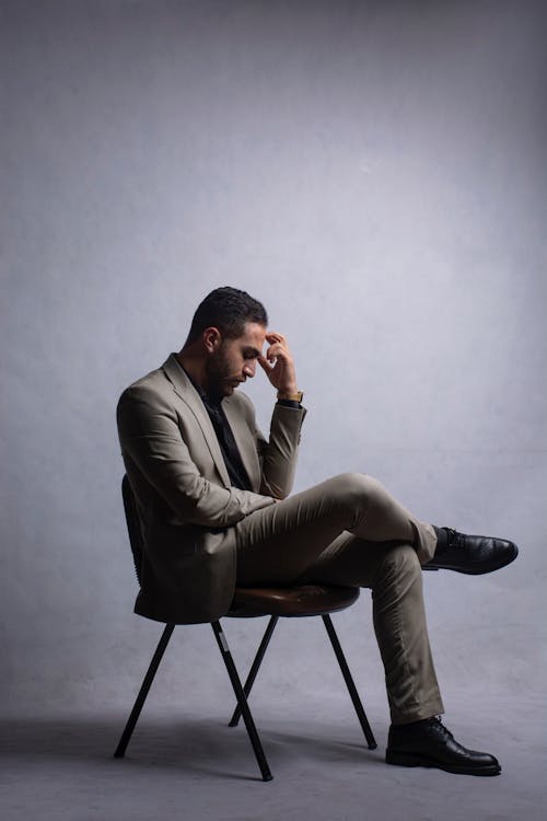 Man in Suit Sitting and Thinking