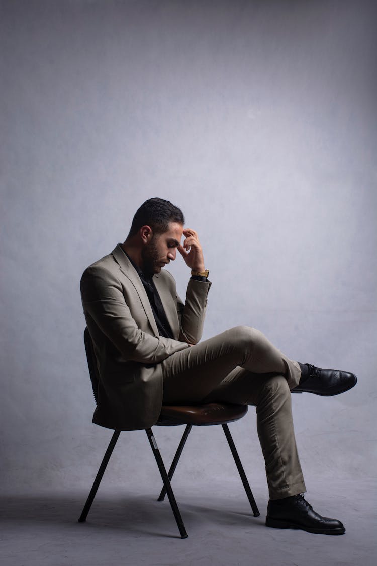 Man In Suit Sitting And Thinking