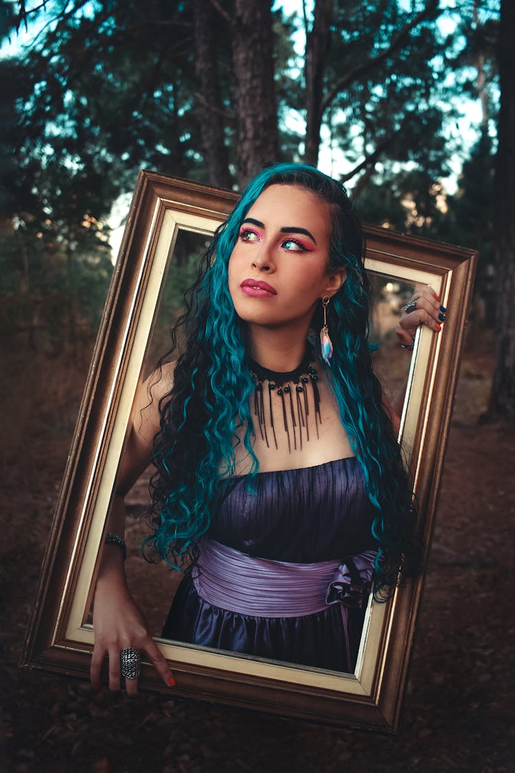 Editorial Photography Of A Woman Holding Gold Frame In Forest