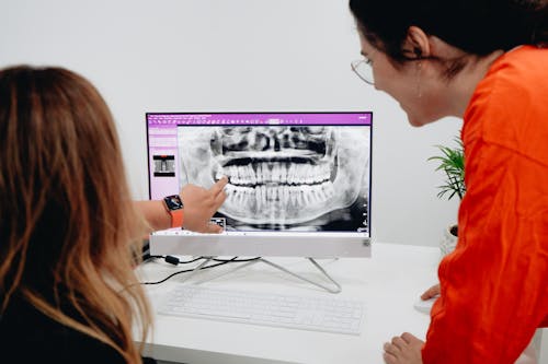 Women Looking at a Dental X-ray on a Computer 