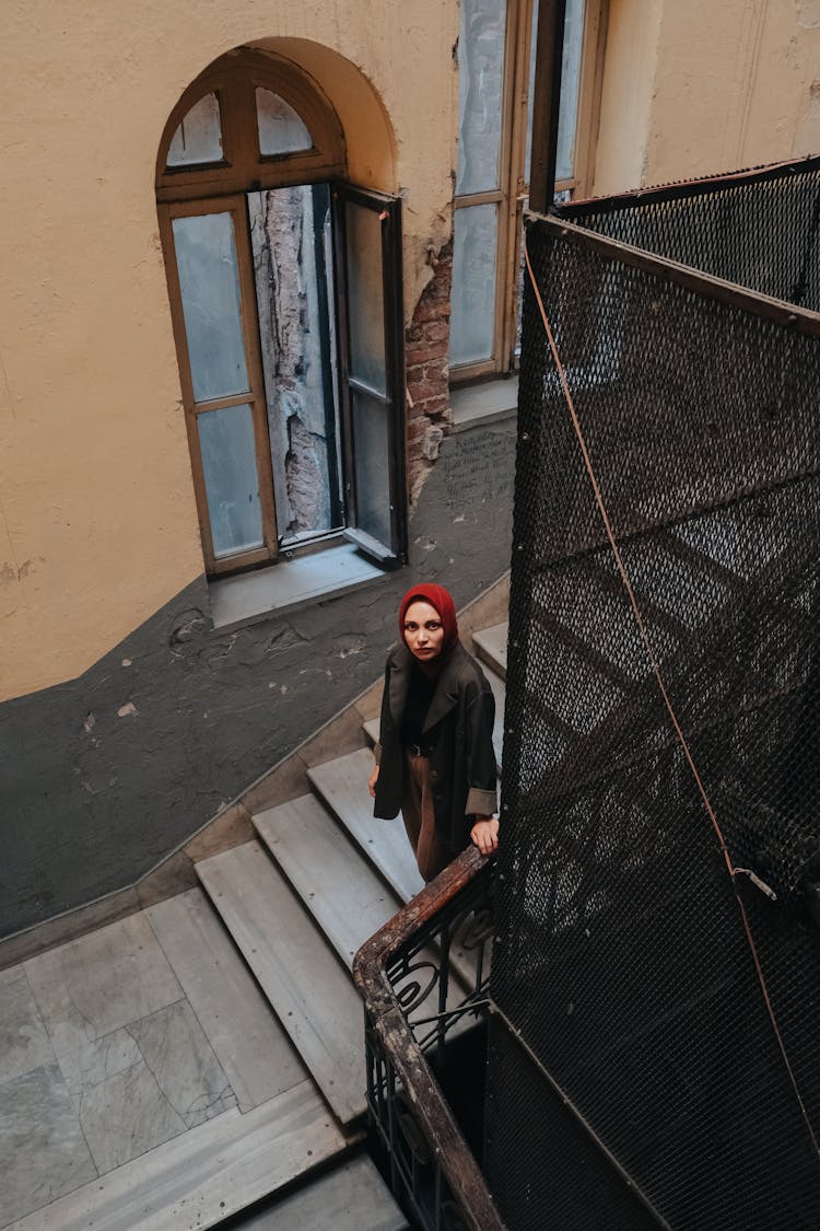 Woman In Hijab Walking Stairs In Old Building 