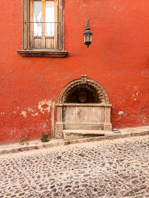 Red Townhouse Wall and Cobblestone Road