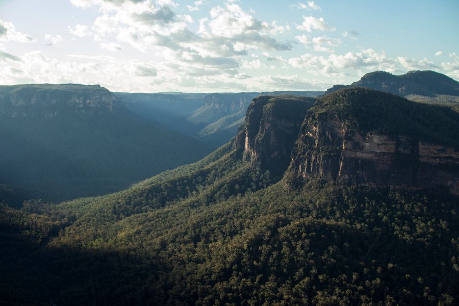 Aerial view of a green mountain valley trail