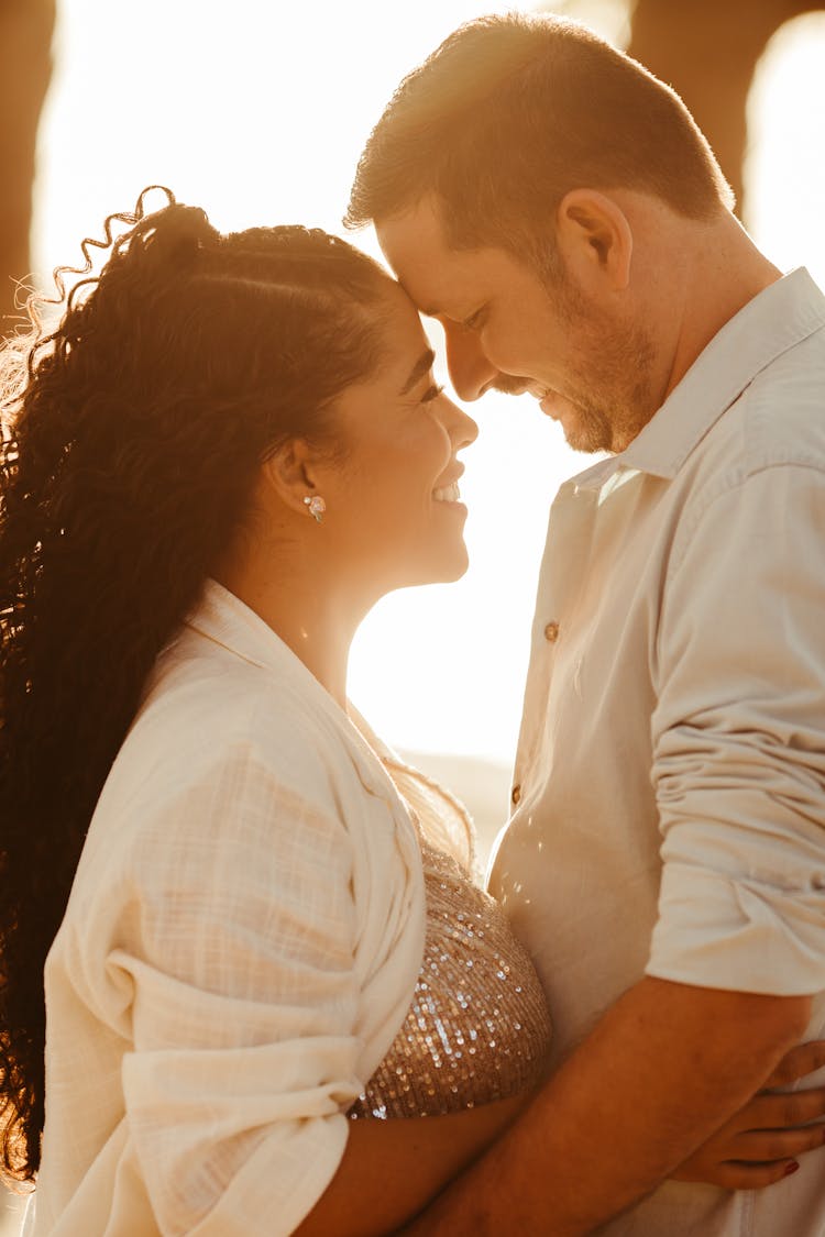 Happy Couple Hugging On Sunset