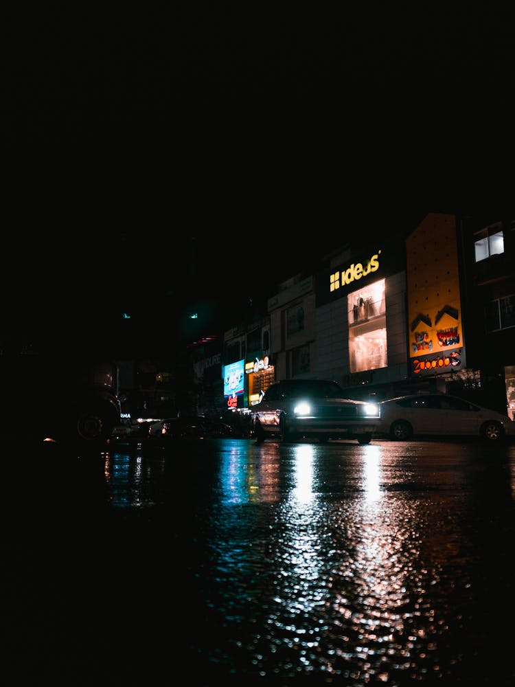 Car Driving On Wet Road At Night