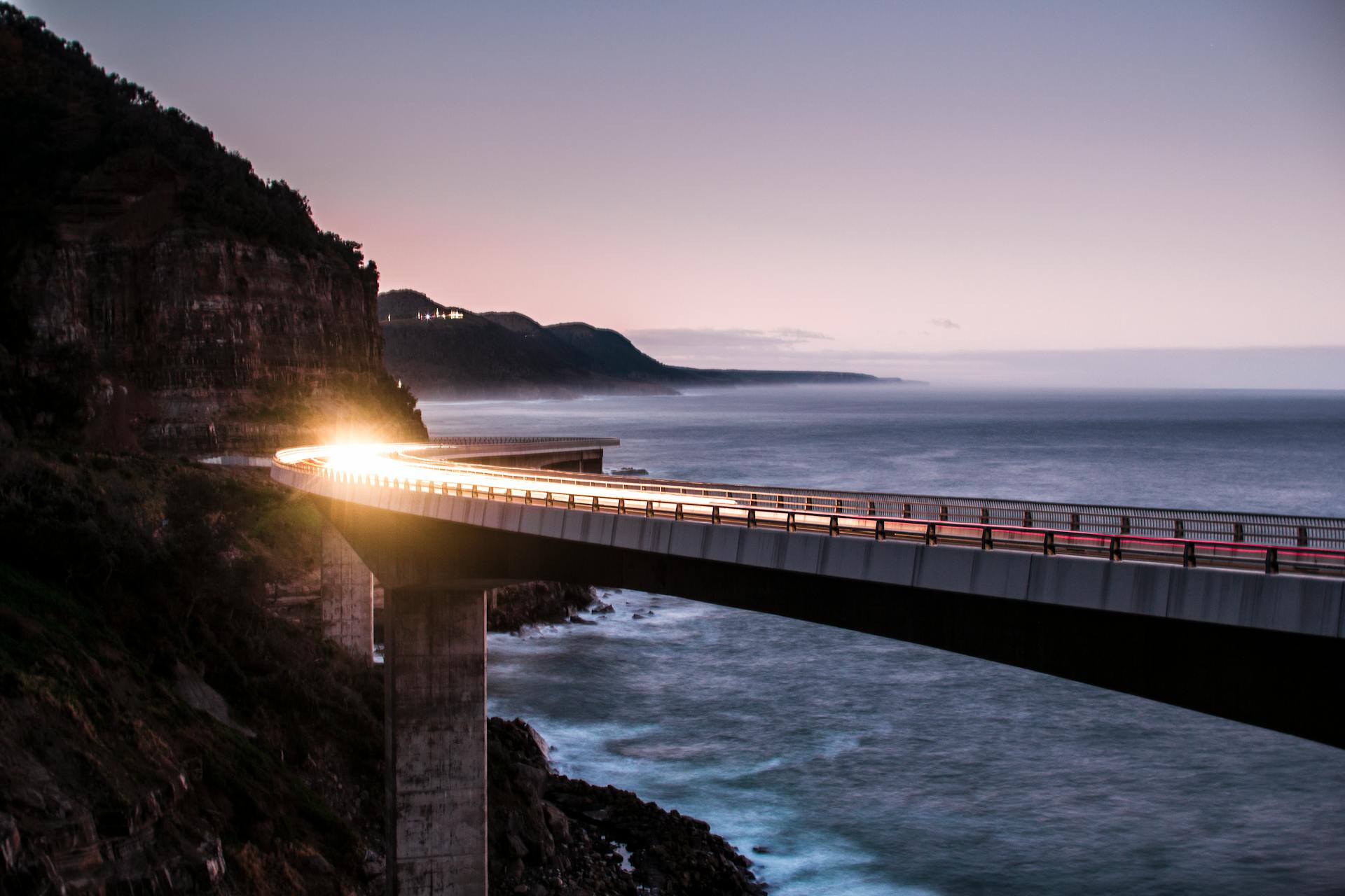 Car Lights on the Sea Cliff Bridge on the Australian Pacific Ocean Coast