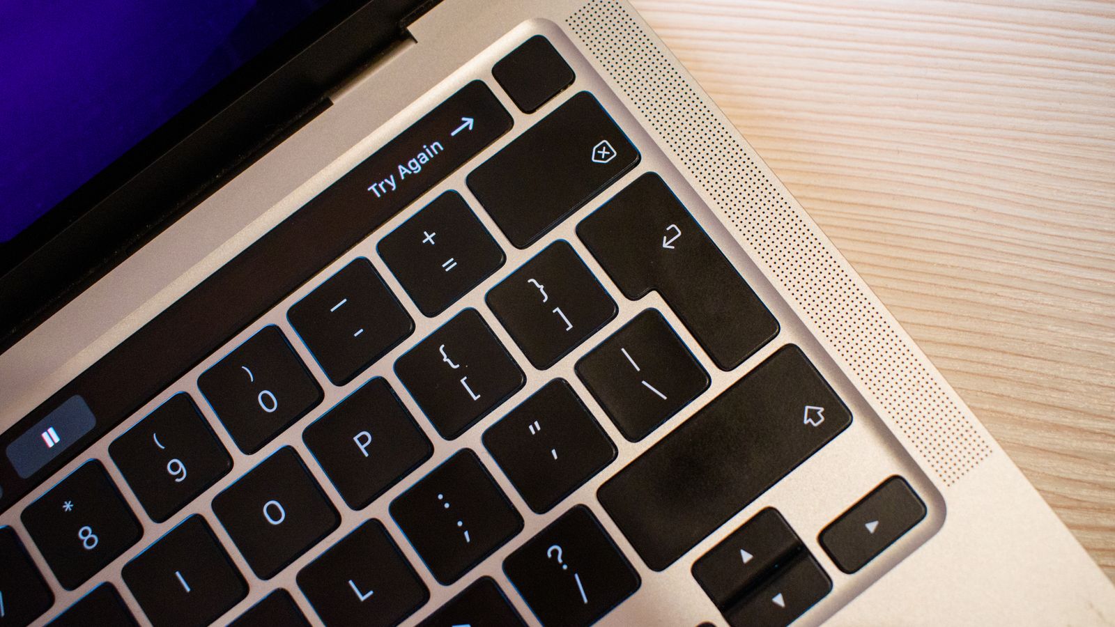 A laptop keyboard on a light wooden table