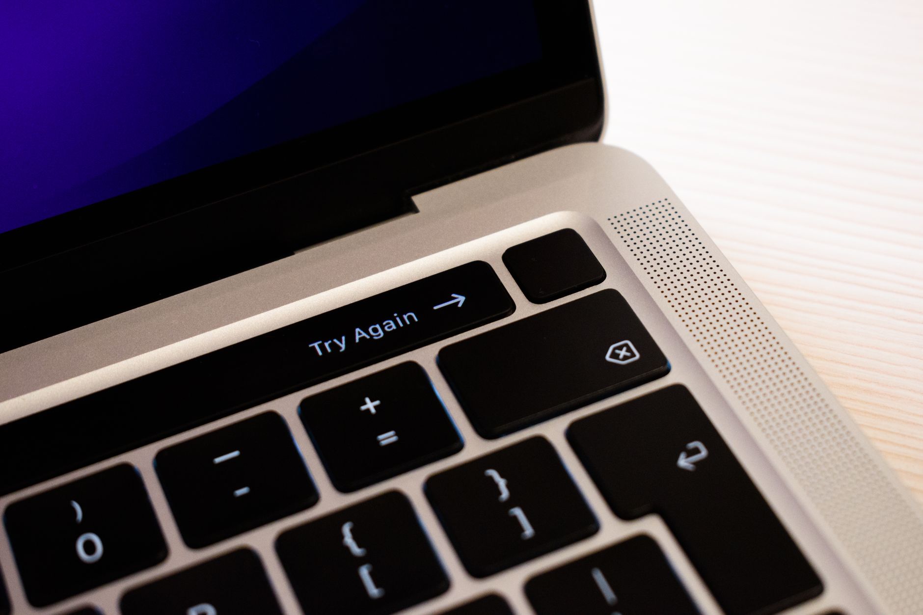 High-resolution close-up of a laptop keyboard featuring a 'Try Again' button.